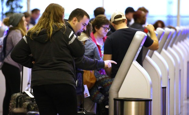 Travelers use electronic kiosks at Midway Airport Nov. 27, 2019. (Antonio Perez/Chicago Tribune)