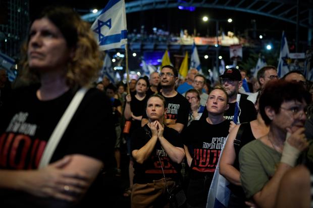 People protest against Prime Minister Benjamin Netanyahu's government and call for the release of hostages held in the Gaza Strip by the Hamas militant group, in Tel Aviv, Israel, Saturday, Sept. 7, 2024. (AP Photo/Leo Correa)