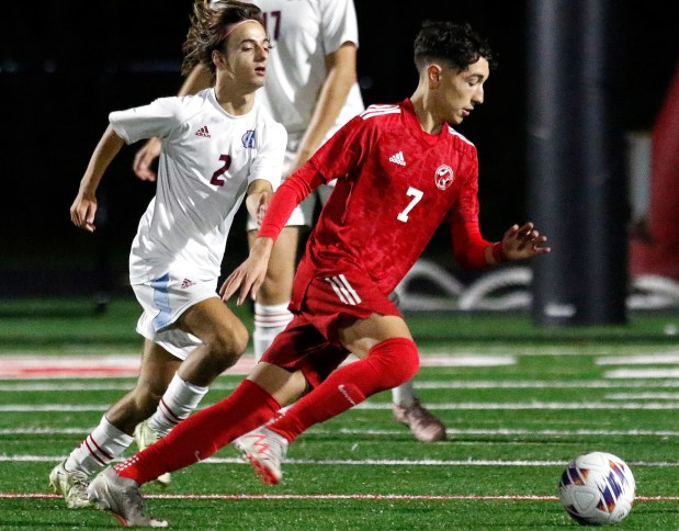 Hanover Central's Evan Brooks, left, pursues Munster's Nikola Dimitrijevic during a Northwest Crossroads Conference game in Munster on Wednesday, Sept. 27, 2023. (John Smierciak / Post-Tribune)