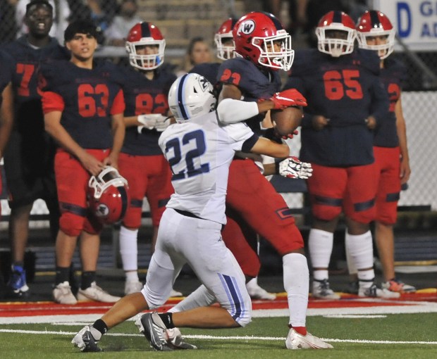 West Aurora's Terrence Smith makes a catch near the sideline as Plainfield South''s Ryan Cramer defends during a Suburban Prairie Conference crossover in Aurora on Friday, Aug. 26, 2022.