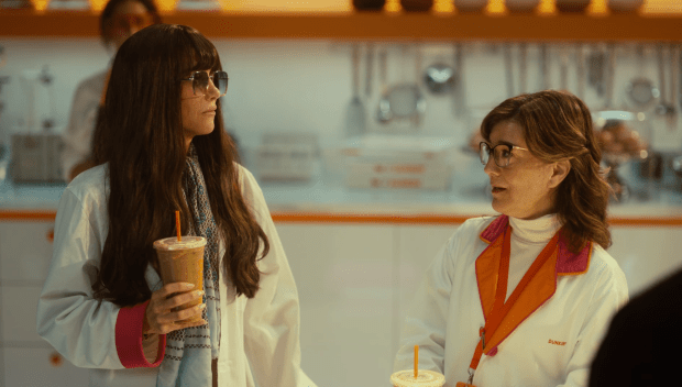 Kristen Wiig in an advertisement for Dunkin holding a Dunkalatte. (Dunkin)