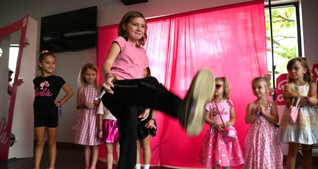 Putting her best foot forward with a kick during the Barbie judging competition is JoJo Jankowski, 9, a fourth-grader from Lindenhurst, at the Launch Party/Birthday Party and Fashion Show at The Rivalry Alehouse at Barbie's Birthday Bash-Family Style on Sept. 28, 2024 in downtown Antioch. (Karie Angell Luc/Lake County News-Sun)