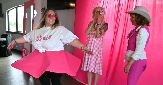 Left, doing a twirl during a competition is parent Lisa Lynch of Antioch. Also seen are contestants, from left, Morgan McConnell of Antioch and Cherie Francois of Bainbridge Island, Washington during the launch party at Barbie's Birthday Bash-Family Style on Sept. 28, 2024 in downtown Antioch. (Karie Angell Luc/Lake County News-Sun)