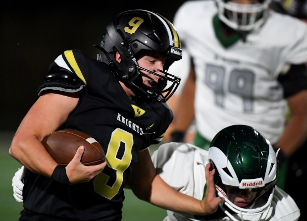 On his way to the endzone, Grayslake North's Landon Dovel (9) pushes Grayslake Central's Devin White (32) to the ground.  Grayslake North hosted cross-town rival Grayslake Central, beating them 28-6 in a conference matchup, Friday, Sept. 27, 2024. (Rob Dicker / News-Sun)