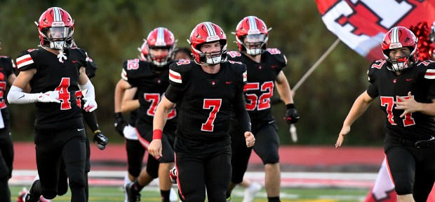 Deerfield quarterback Mac Jones (7) leads the team onto the field before a game against Highland Park in Deerfield on Friday, Sept. 6, 2024. (Rob Dicker / News-Sun)