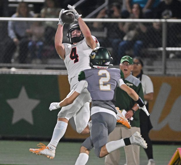 Libertyville's Blaise LaVista (4) pulls in a long pass in front of Stevenson's John Concialdi (2) during the 2nd quarter of Friday's game, Sept. 13, 2024. Libertyville won the game, 43-14. (Brian O'Mahoney for the News-Sun)