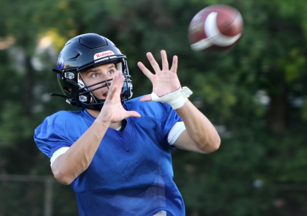 Highland Park wide receiver Lucas Gordon catches a pass from quarterback Michael Bryant during practice Wednesday, Sept. 4, 2024 at Wolters Field in Highland Park. (George LeClaire/for the News Sun)