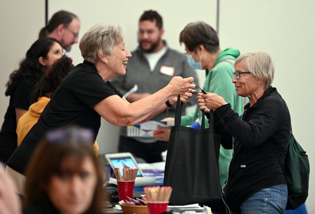 Top right, in green jacket, Elizabeth Adamczyk of Deerfield visits the Ellie Mental Health table at the Healthy Lifestyle Expo on Sept. 7, 2024 in Deerfield at the Patty Turner Center. (Karie Angell Luc/Lake County News-Sun)