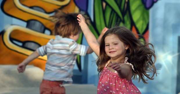 Right, Harlow Pierce, 4, of Highland Park dances to the live music of the band Epsilon+ playing at the new Mural Park Pavilion during Nashwood on Aug. 31, 2024 in Highwood. (Karie Angell Luc/Lake County News-Sun)