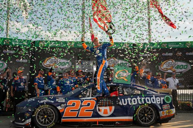 Joey Logano, center, celebrates after winning a NASCAR Cup Series auto race at Atlanta Motor Speedway, Sunday, September 8, 2024, in Hampton, Ga. (Hyosub Shin/Atlanta Journal-Constitution via AP)