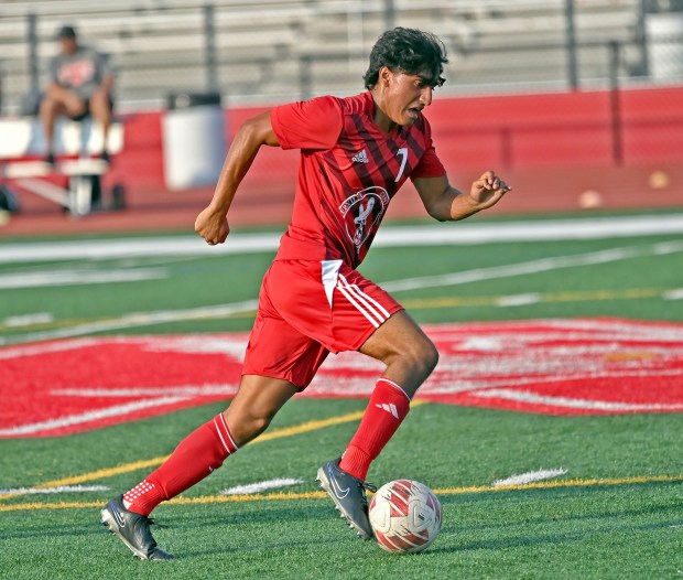 Naperville Central's Aidan DiClemente dribbles the ball away from a Plainfield North defender. Naperville Central defeated Plainfield North in a boys soccer game, 2-1, Wednesday, Sept. 5, 2024, in Naperville, Illinois. (Jon Langham/for Naperville Sun)