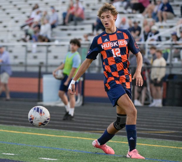 Naperville North's Colin McMahon (12) takes control of the ball against Naperville Central during an overtime 4-3 win at home on Tuesday, Sept. 17, 2024. (Mark Black / The Naperville Sun)