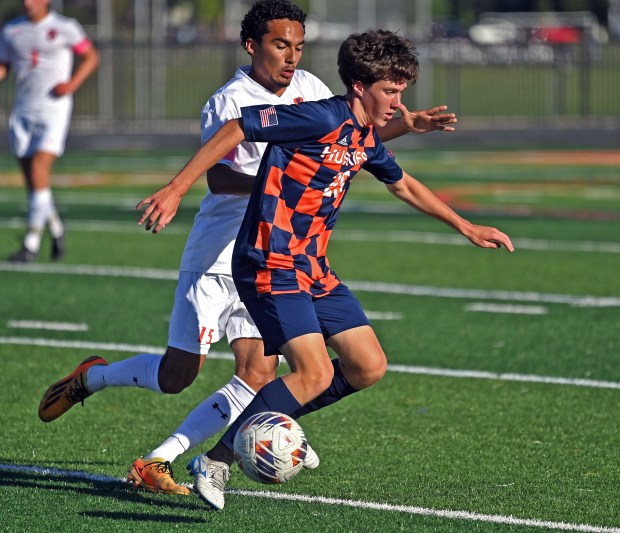 Naperville North's Dylan Healy dribbles the ball ahead of Oswego's Noe Parra. Naperville North defeated Oswego in a boys soccer game, 6-0, Tuesday, Sept. 3, 2024, in Naperville, Illinois. (Jon Langham/for Naperville Sun)