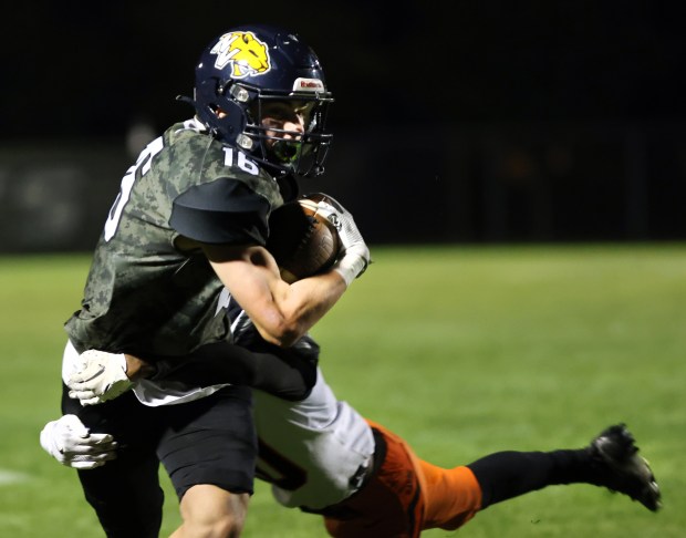 Neuqua Valley's Andrew Barkley runs the ball against DeKalb during the game in Naperville on Friday, Sept. 27, 2024. (James C. Svehla / Naperville Sun)