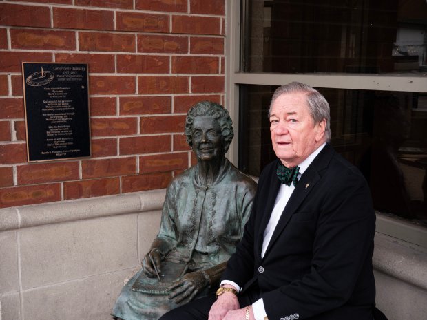 Brand Bobosky, seated next to one of the sculptures commissioned by the Century Walk Corp., says he plans to step down as president of the nonprofit organization at the end of the year. Since its inception in 1996, more than 50 murals, sculptures, mosaics and other art pieces have been placed throughout Naperville. (Tess Kenny/Naperville Sun)