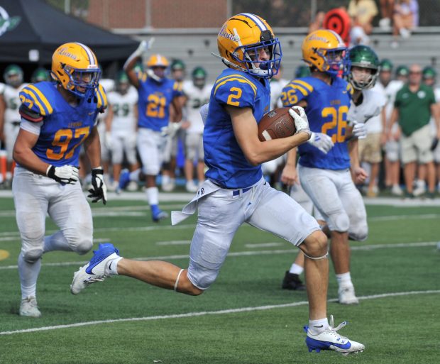 Lyons Lions Travis Stamm (2) runs the ball in for a touchdown after intercepting it during the second half of a West Suburban Silver Conference football game against the Glenbard West Hilltoppers on Saturday, Sept. 21, 2024, in Western Springs, IL. (Patrick Gorski/for the Pioneer Press)