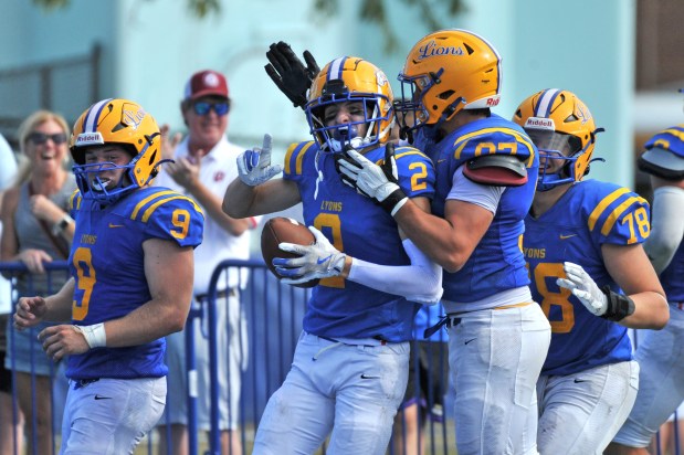 Lyons Lions Travis Stamm (2) celebrates his touchdown with teammates during the second half of a West Suburban Silver Conference football game against the Glenbard West Hilltoppers on Saturday, Sept. 21, 2024, in Western Springs, IL. (Patrick Gorski/for the Pioneer Press)