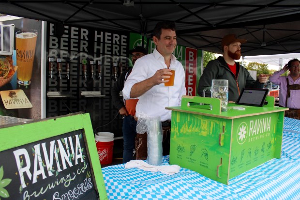 Andrew Devlin, master brewer at Ravinia Brewing Company (center), during Oktoberfest on Saturday, Sept. 28 at the Lot in Highland Park. (Gina Grillo/ For the Pioneer Press)