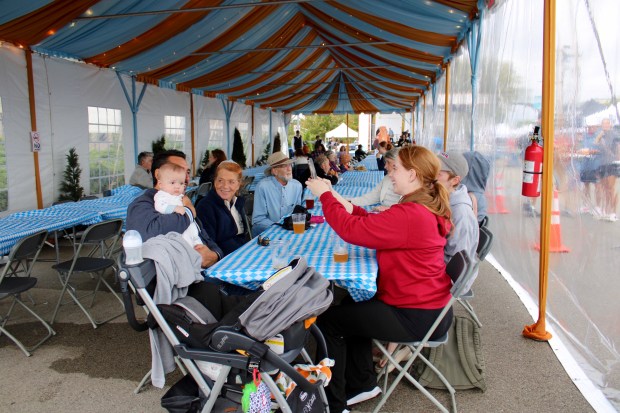 Oktoberfest-style food and entertainment included a beer stein-holding contest, hammer-schlagen, axe throwing, a high-striker, ring-o, corn hole, pretzel necklace making, and much more. Long tents accommodated communal Oktoberfest seating encouraging community spirit in Highland Park. (Gina Grillo/ For the Pioneer Press)