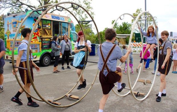 Interactive fun with the show team performers from CirquesExperience Wheel Show during Oktoberfest on Saturday, Sept. 28 at the Lot in Highland Park. (Gina Grillo/ For the Pioneer Press)