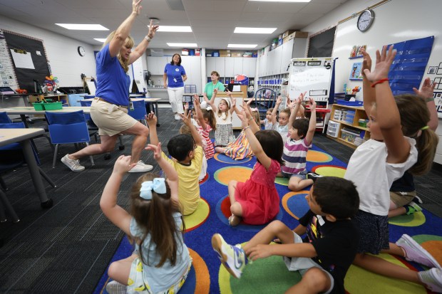 Teacher Karen Pullam, left, interacts with her kindergarten students on the first day of school Aug. 28, 2024 at Patton Elementary School in Arlington Heights. (Talia Sprague/for Pioneer Press)