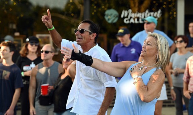 Dancing, from left to right are Frank Bravato, formerly of Lake Zurich and now of Phoenix, Arizona, and Jorie Schaeffer of Hawthorn Woods at Rock the Block on Saturday, Sept. 14, 2024 in downtown Lake Zurich. (Karie Angell Luc/Pioneer Press)