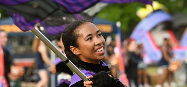 Performing with the Northwestern University Marching Band color guard is Rachel Spears, a student from Massachusetts during the annual 'Kits, 'Cats & Kids Block Party on Thursday, Sep. 5, 2024 at the Evanston Township High School Lazier Field in Evanston. (Karie Angell Luc/Pioneer Press)