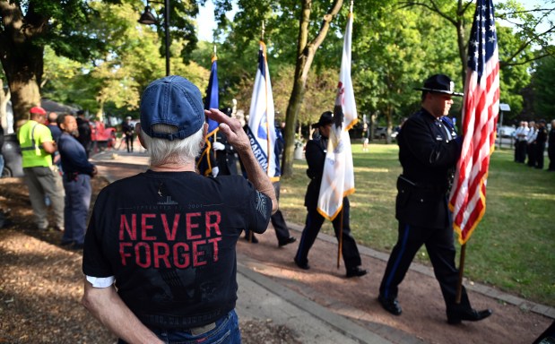 A salute as the Honor Guard makes an exit at the end of the City of Evanston Patriot Day Remembrance Ceremony on Sept. 11, 2024 at Firefighter's Park in Evanston. (Karie Angell Luc/Pioneer Press)