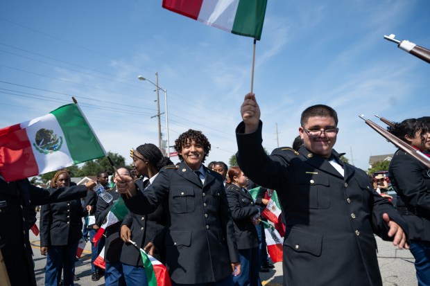 East Chicago Central JROTC members wave Mexican flags as they particpate in the Fiestas Patrias Parade in East Chicago on Sunday, Sept. 15, 2024. (Kyle Telechan/for the Post-Tribune)