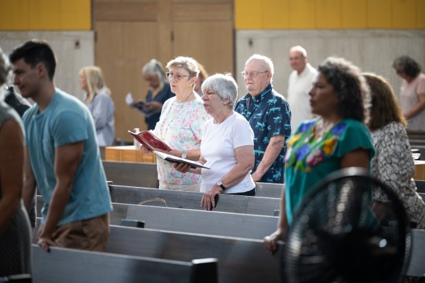 Congregants stand and sing during mass at St. Mary of the Lake Catholic church in Gary on Sunday, Sept. 15, 2024. (Kyle Telechan/for the Post-Tribune)