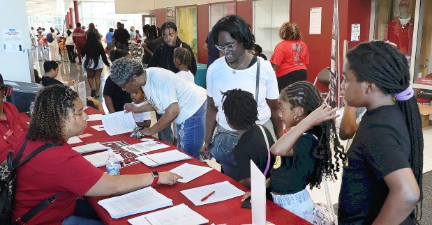 Parents sign up their children during the Back to School Jamboree hosted by IU Northwest, previously organized by Indiana State Rep. Vernon Smith. After many years of involvement, Rep. Smith has elected to transition the event to IU Northwest. The ceremony took place on Saturday, Sept. 14, 2024. (John Smierciak/Post Tribune)