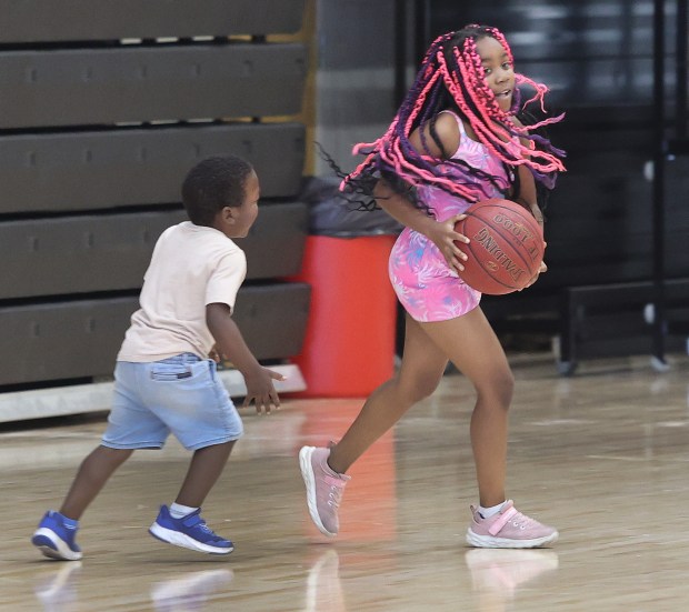 Grayson Williams 4, (left) chases after his sister Genesis Williams 9, (right) after she stole his ball during the Back to School Jamboree hosted by IU Northwest, previously organized by Indiana State Rep. Vernon Smith. After many years of involvement, Rep. Smith has elected to transition the event to IU Northwest. The ceremony took place on Saturday, Sept. 14, 2024. (John Smierciak/Post Tribune)