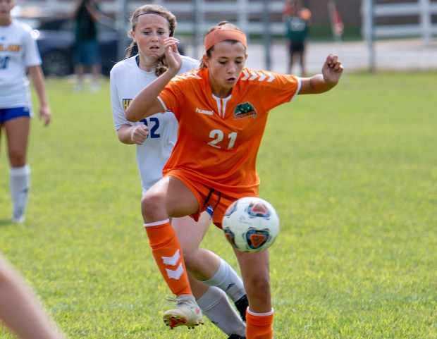 Wheeler's Grace Christos, front, tries to control the ball against Highland's Madison Turpin during a game in Valparaiso on Saturday, Sept. 4, 2021. (Michael Gard / Post-Tribune)