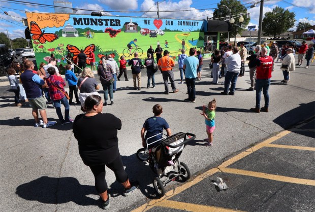 Residents listen to speakers during the Munster Police Department's unveiling of a mural on the northeast corner of Ridge Rd. and Meadow Ave. in Munster. The Munster Police Department Choice Community Council created its first anticrime/beautification mural and organizers hope it is the first of many. The ceremony took place on Saturday, Sept. 7, 2024. (John Smierciak/Post Tribune)