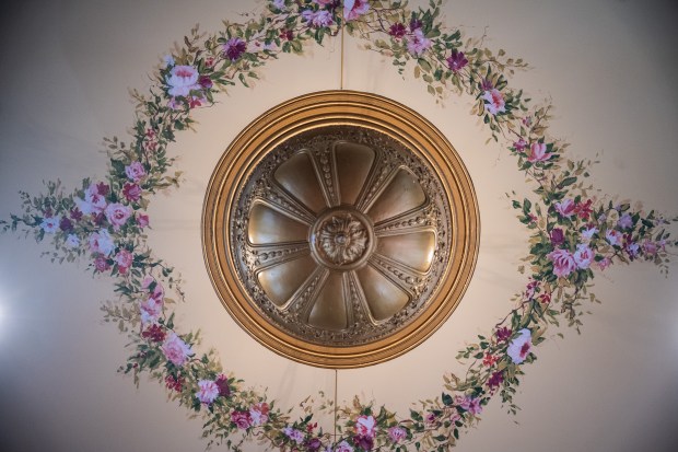 Painted flowers surround a light fixture on the ceiling of the newly-remodeled Memorial Opera House during a ceremony to rededicate the Valparaiso building on Friday, Sept. 13, 2024. (Kyle Telechan/for the Post-Tribune)