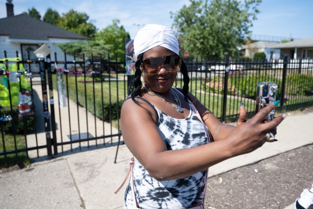 Gary resident Gina Weatherspoon takes a selfie in front of the Jacksons' childhood home as fans gather at the Jackson family home in Gary to mourn Tito Jackson's death on Monday, Sept. 16, 2024. (Kyle Telechan/for the Post-Tribune)