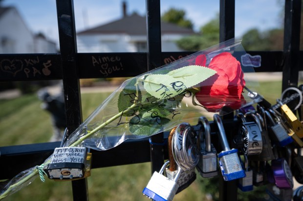 A rose with the message "RIP Tito, Love you forever" written on it hangs on the fence outside of the Jackson family home in Gary as visitors mourn the artist's death on Monday, Sept. 16, 2024. (Kyle Telechan/for the Post-Tribune)