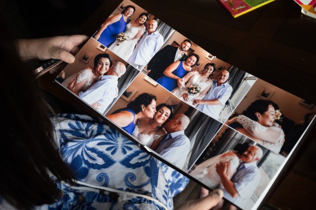 Crown Point resident Elmira Miocic, who moved to the U.S. from Ukraine four years ago, looks at photos of her family and friends who are still in Ukraine as she flips through her wedding album in her Crown Point home on Wednesday, Sept. 11, 2024. (Kyle Telechan/for the Post-Tribune)