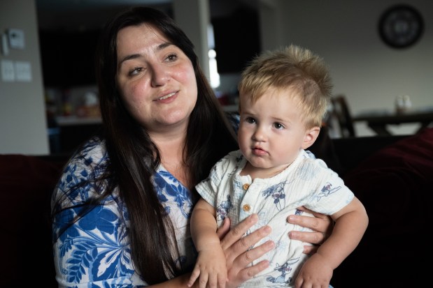 Crown Point resident Elmira Miocic holds her son Alan, 1, as she speaks about her journey to the US and past efforts to bring her family over from Ukraine, in her Crown Point home on Wednesday, Sept. 11, 2024. (Kyle Telechan/for the Post-Tribune)