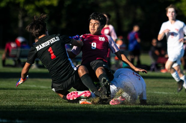 Homewood-Flossmoor's keeper Jefferson Mansfield (1) slides to break up an attacking Omar Reyes (9) of T.F. United during a nonconference game in Calumet City on Wednesday, Sept. 4, 2024. (Vincent D. Johnson / Daily Southtown)