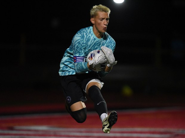 Lincoln-Way East's Noah Brown (1) runs up to grab the ball against Lincoln-Way Central during a SouthWest Suburban Conference game Thursday, Sept. 26, 2024 in New Lenox, IL. (Steve Johnston / Daily Southtown)