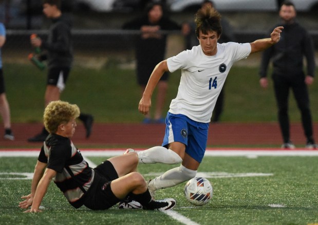 Lincoln-Way East's Owen Bohren (14) works past Lincoln-Way Central's Chuck Stevens (19) during a SouthWest Suburban Conference game Thursday, Sept. 26, 2024 in New Lenox, IL. (Steve Johnston / Daily Southtown)