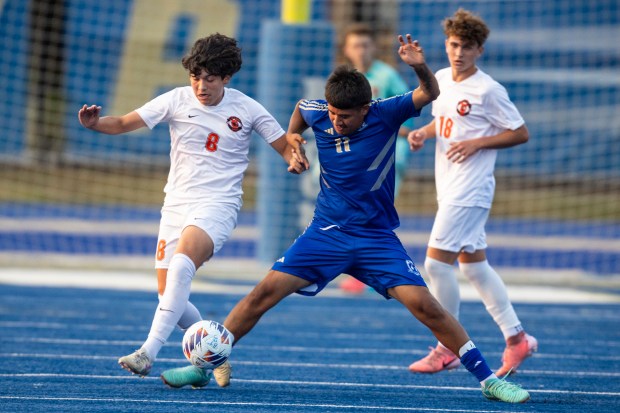 Lincoln-Way West's Adrian Ontiveros (8) and Bloom Township's Omar Ortiz (11) go for a ball during a nonconference game in Chicago Heights on Tuesday, Sept. 10, 2024. (Vincent D. Johnson / Daily Southtown)