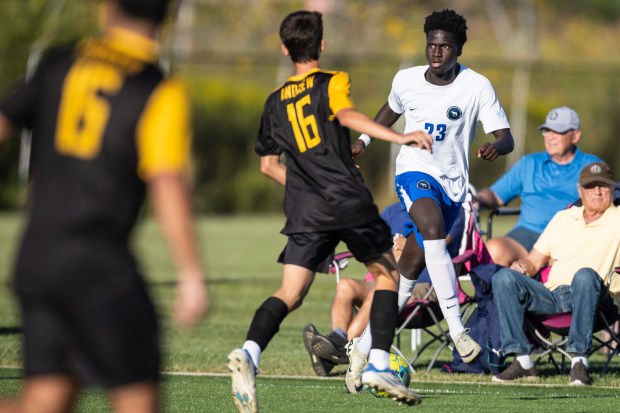 Lincoln-Way East's Dennis Apraku (23) brings the ball up against Andrew during the Windy City Ram Classic semifinals at Reavis in Burbank on Tuesday, Sept. 3, 2024. (Vincent D. Johnson / Daily Southtown)