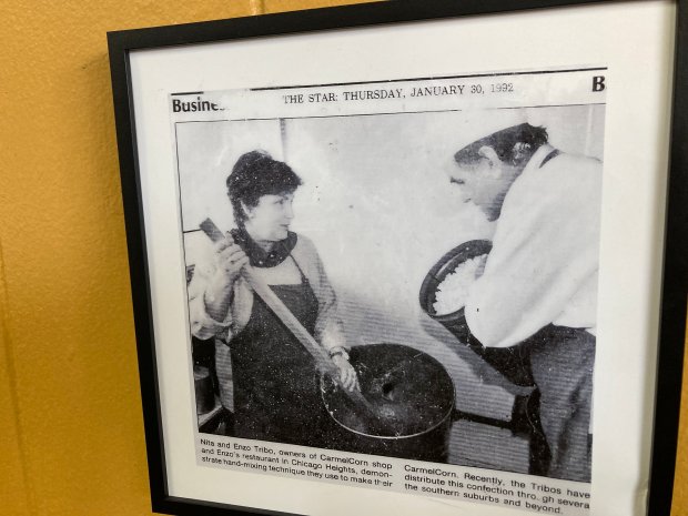 A 1992 photograph from a Star Newspapers story on display at Enzo's & CarmelCorn in Chicago Heights shows Nita and Enzo Tribo cooking up a batch of their signature popcorn treat. The couple retired in 2011 and the business closed in March. (Paul Eisenberg/Daily Southtown)