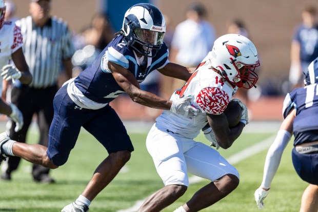 Reavis' Jorden Brown (2) tries to bring Eisenhower's Andre Lovett (14) down from behind during a South Suburban Red game in Burbank on Saturday, Sept. 21, 2024. (Vincent D. Johnson / Daily Southtown)