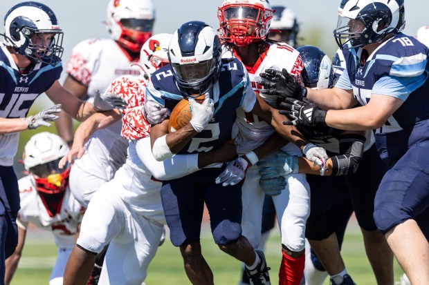 Reavis' Jorden Brown (2) busts through the Eisenhower defensive line with a pair of tacklers hanging on during a South Suburban Red game in Burbank on Saturday, Sept. 21, 2024. (Vincent D. Johnson / Daily Southtown)