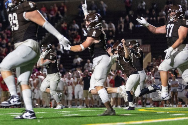 Joliet Catholic's Vinny DiNovo (1) runs back to the sidelines after hitting the game-winning extra point in overtime against Marist during a CCL/ESCC Green game in Joliet on Friday, Sept. 20, 2024. (Vincent D. Johnson / Daily Southtown)