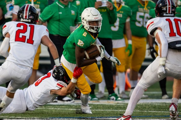 Providence's Xavier Coleman (2) turns up field as Lincoln-Way Central's Nolan Morrill (3) tries to bring him down during a nonconference game in New Lenox on Friday, Sept. 6, 2024. (Vincent D. Johnson / Daily Southtown)