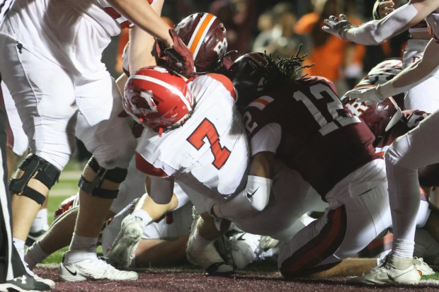 Marist's John McAuliffe (7) scores a touchdown in overtime against Brother Rice during a CCL/ESCC crossover game in Chicago on Friday, Sept. 6, 2024. (Troy Stolt / Daily Southtown)